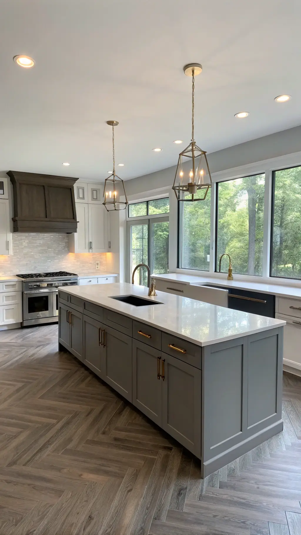 Bright and airy contemporary kitchen with dove gray shaker cabinets, white quartz countertops, a charcoal island, white oak herringbone floors, and pendant lights, illuminated by morning light from floor-to-ceiling windows.