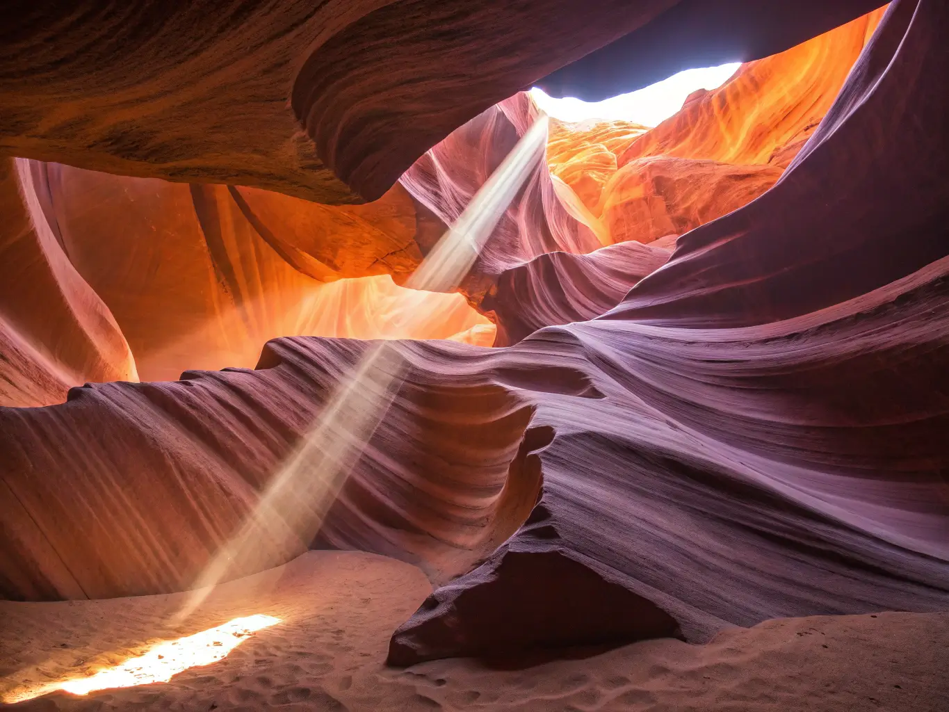 Overhead shot of Antelope Canyon's curving sandstone walls illuminated by sunlight penetrating through a narrow opening